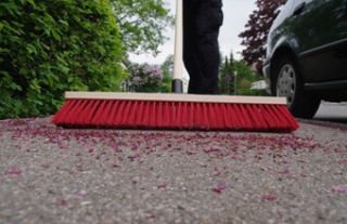 Sweeping sidewalk with broom