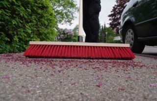 Sweeping sidewalk with broom Sweeping sidewalk with broom
